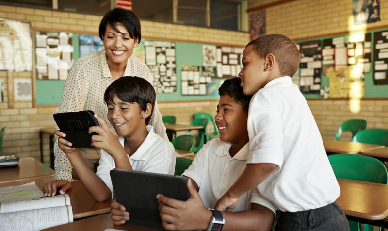 teachers and students viewing tablets