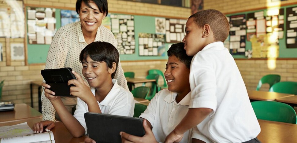 teachers and students viewing tablets