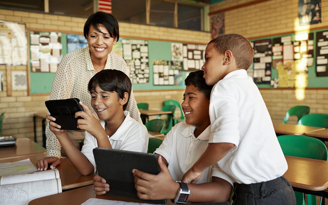 teachers and students viewing tablets