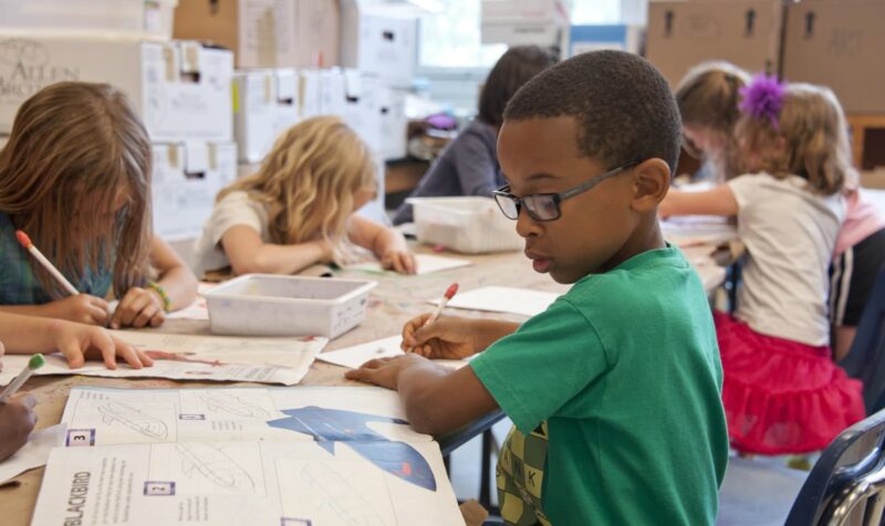 students sitting at a table in a classroom