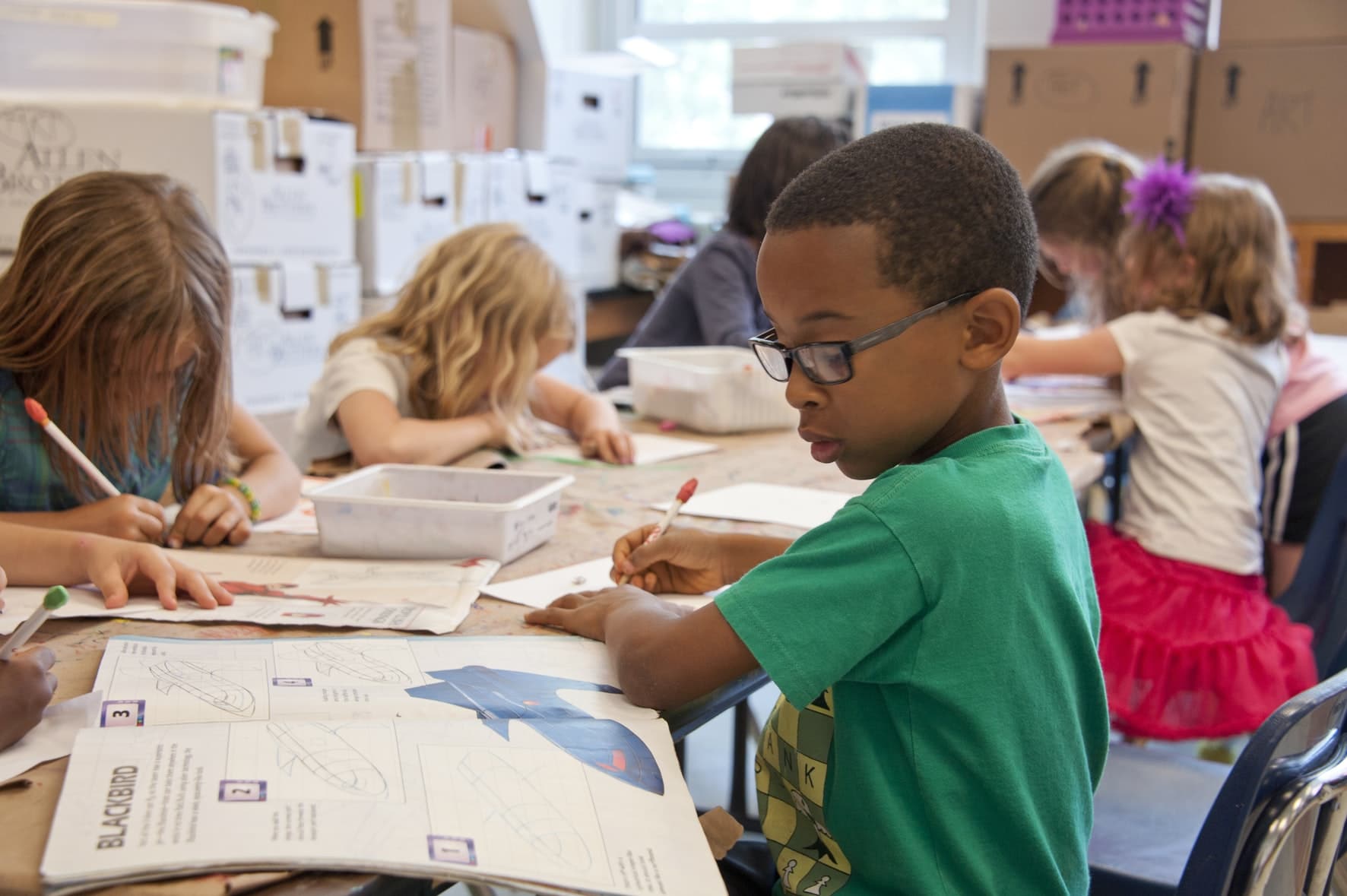 students sitting at a table in a classroom