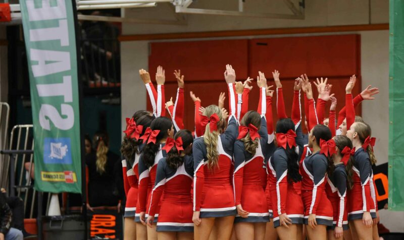 Cheerleading Squad with Hands Raised