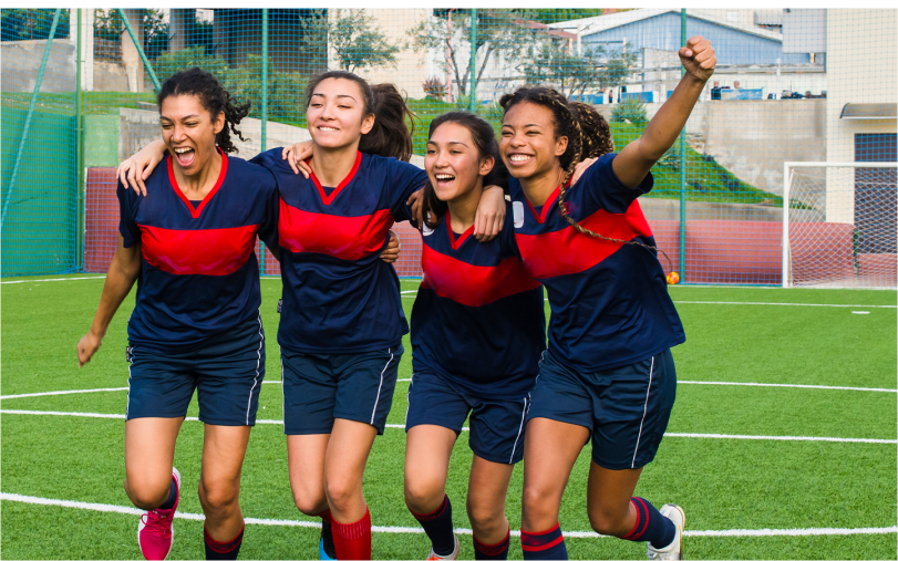 Soccer players cheering.