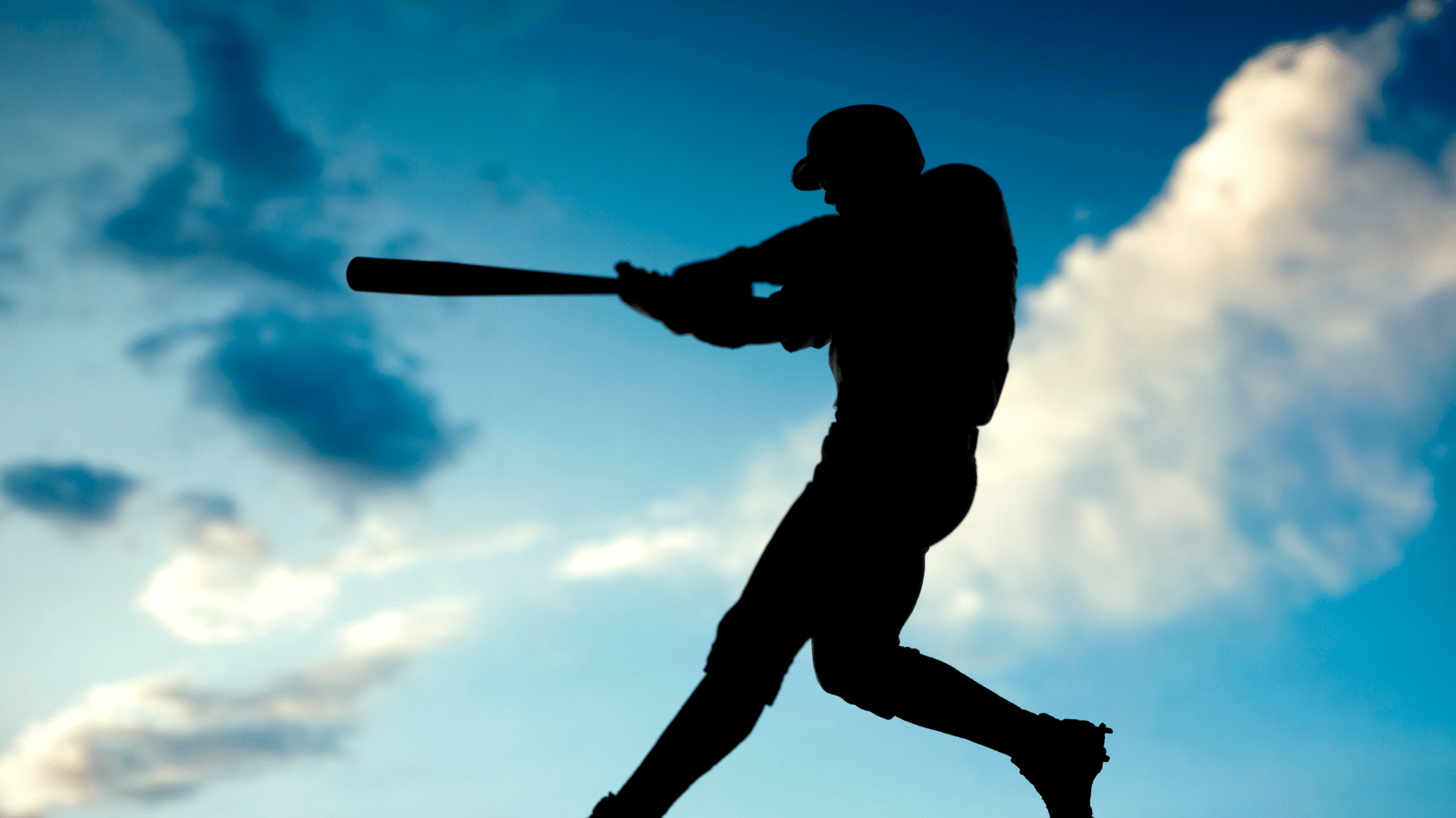 silhouette of batter swinging a bat