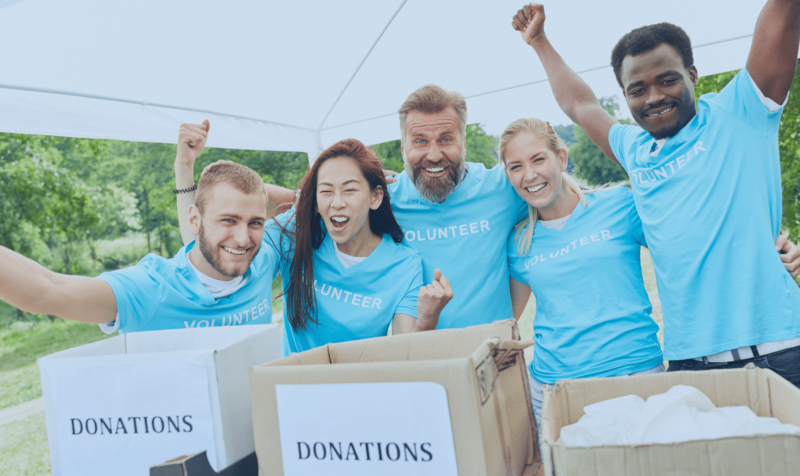 volunteers with arms raised